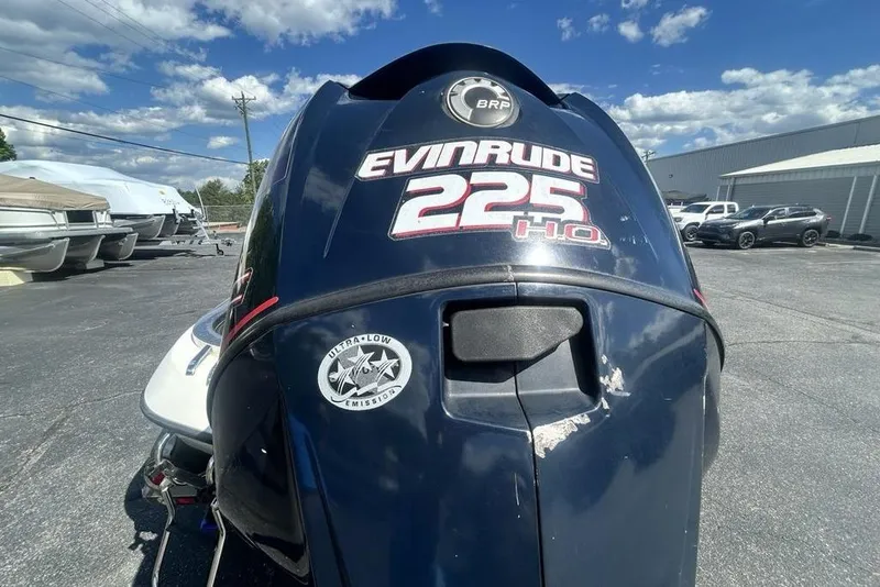 Slide: The Image of 2007 Ranger Z20 boat with Evinrude 225 HO engine in a parking lot. - 13
