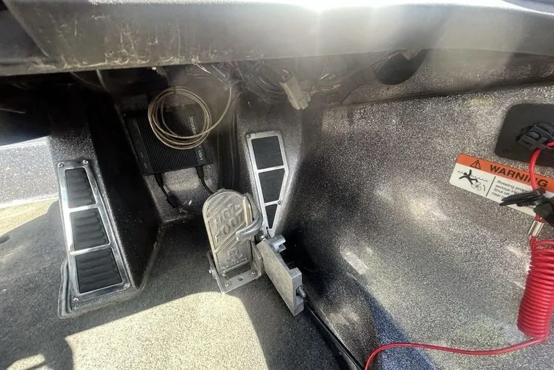 Slide: The Image of Foot pedal area of a 2007 Ranger Z20 boat with warning label and wiring. - 14