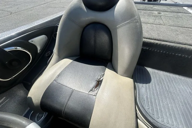 Slide: The Image of 2007 Ranger Z20 boat seat with visible wear and tear on the upholstery. - 15