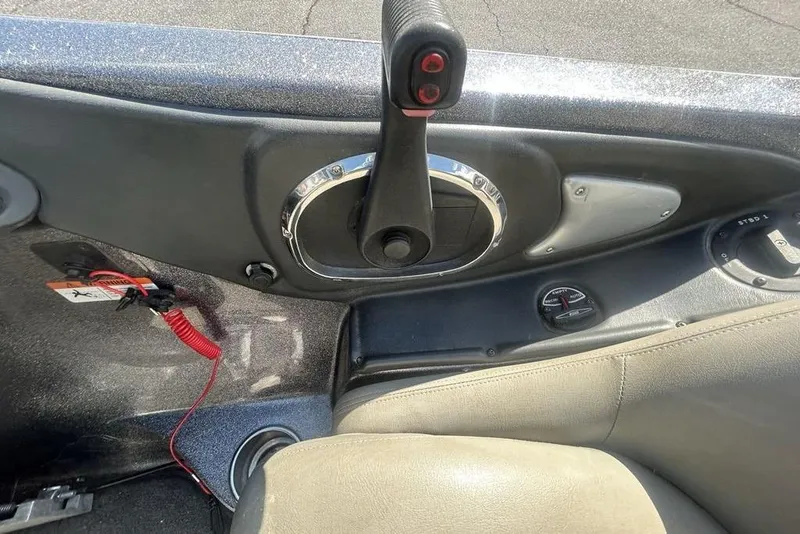 Slide: The Image of Interior view of a 2007 Ranger Z20 boat showing control panel and seat. - 16