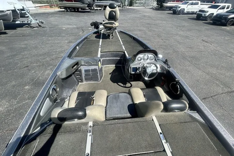 Slide: The Image of 2007 Ranger Z20 boat interior with steering wheel and seating, parked on asphalt. - 17