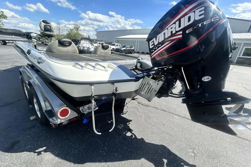 Slide: The Image of 2007 Ranger Z20 boat with Evinrude E-TEC motor on trailer, parked outdoors. - 22