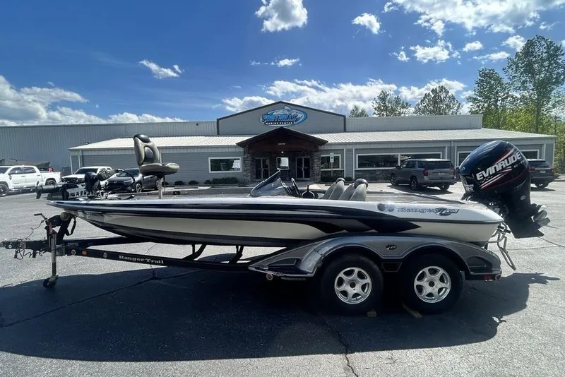 Slide: The Image of 2007 Ranger Z20 boat with Evinrude motor on trailer, parked outside dealership. - 25