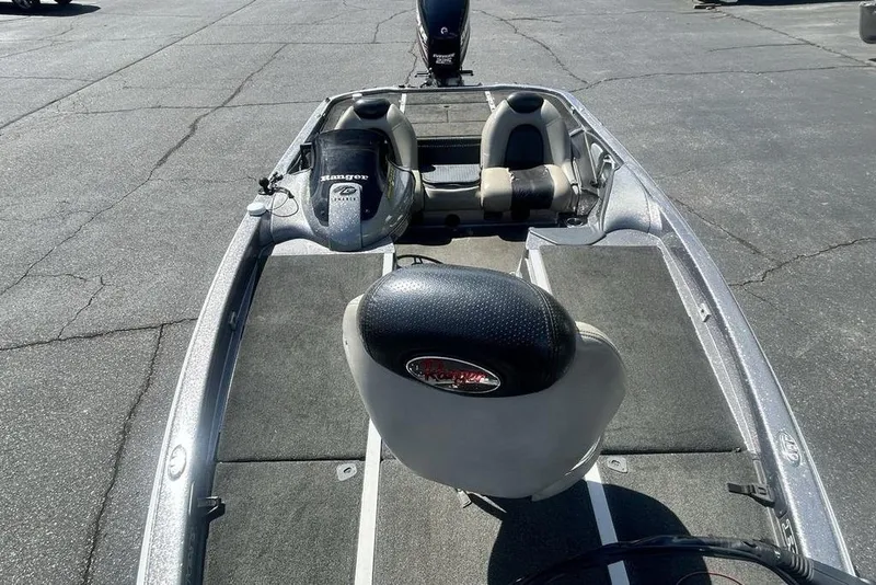 Slide: The Image of 2007 Ranger Z20 boat interior with seating and steering wheel on pavement. - 4
