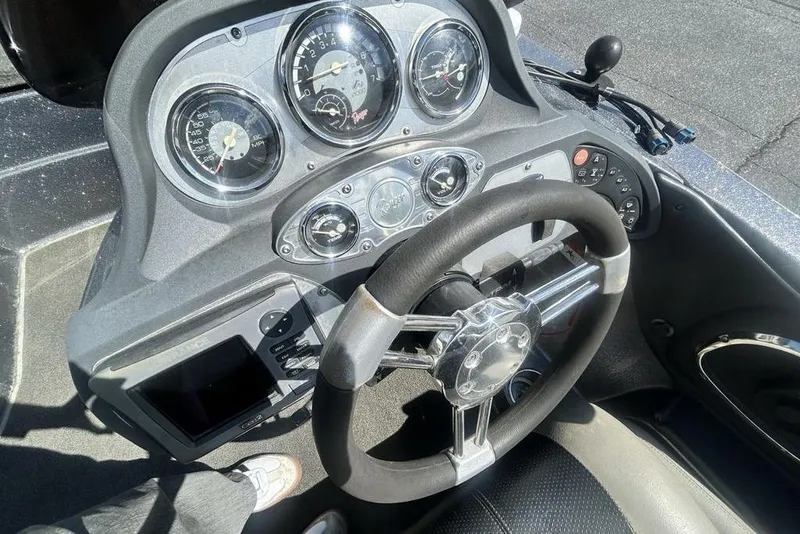 Slide: The Image of Dashboard of a 2007 Ranger Z20 boat with steering wheel and gauges. - 5