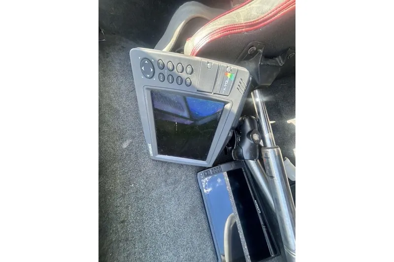 Slide: The Image of 2007 Ranger Z20 boat electronics, including Lowrance and Garmin devices, on carpeted floor. - 6