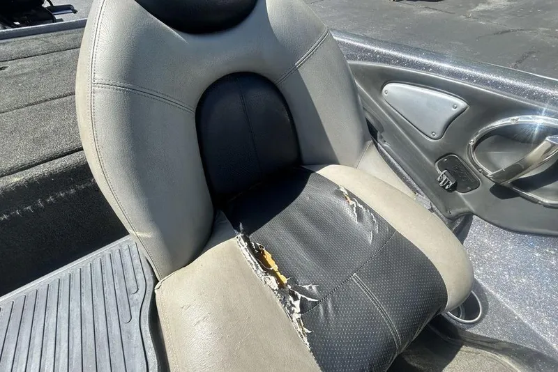 Slide: The Image of Worn seat in a 2007 Ranger Z20 boat, showing visible tears and damage. - 7