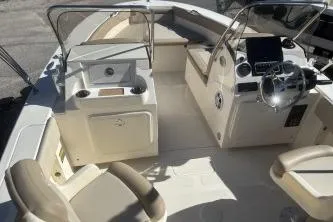 Slide: The Image of 2024 Scout 195 Sport Dorado boat interior with seating and steering console. - 4