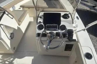 Slide: The Image of 2024 Scout 195 Sport Dorado boat interior with steering wheel and control panel. - 5