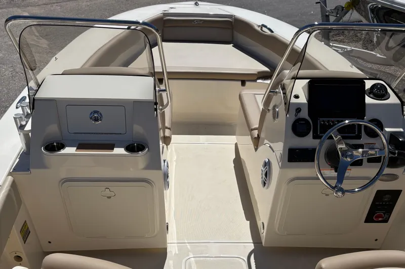 Slide: The Image of 2024 Scout 195 Sport Dorado boat interior with steering wheel and seating area. - 6