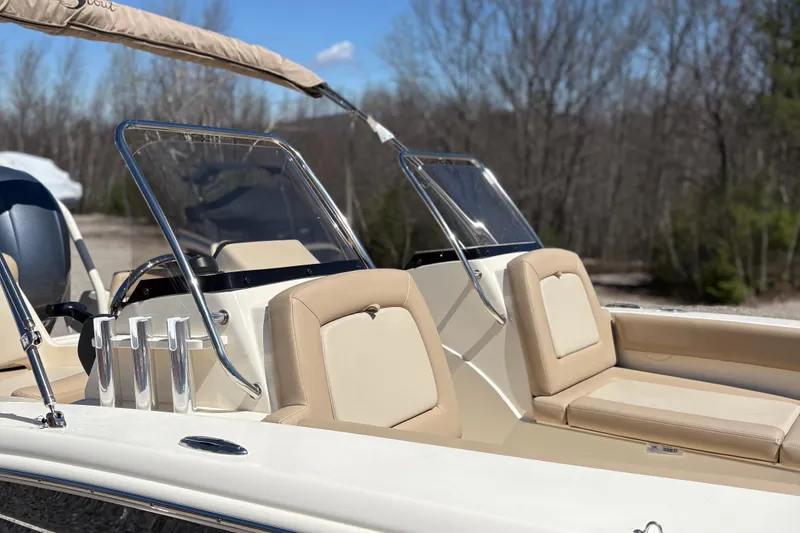 Slide: The Image of 2024 Scout 195 Sport Dorado boat with beige seating and dual windshields. - 8