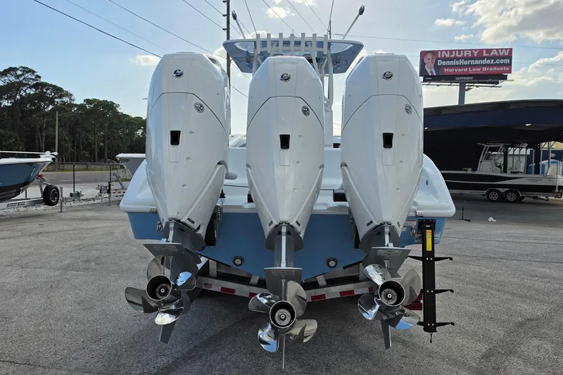 Slide: The Image of 2026 Yellowfin 36 Offshore boat with triple outboard engines, parked on a trailer. - 10