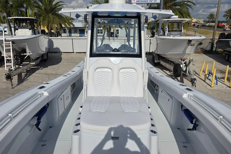 Slide: The Image of 2026 Yellowfin 36 Offshore boat with sleek design, docked near palm trees. - 12