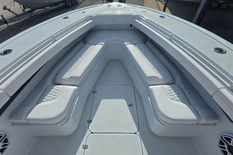 Slide: The Image of 2026 Yellowfin 36 Offshore boat interior with cushioned seating and storage compartments. - 13