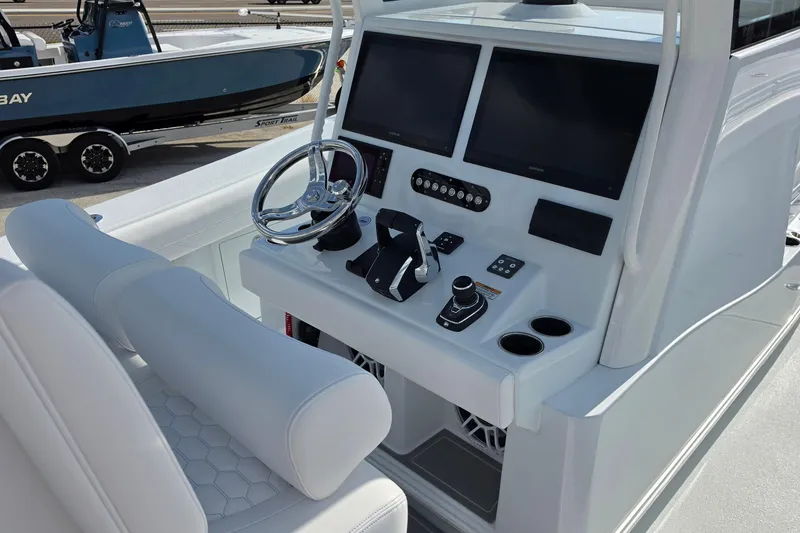 Slide: The Image of 2026 Yellowfin 36 Offshore boat dashboard with dual screens and modern controls. - 14
