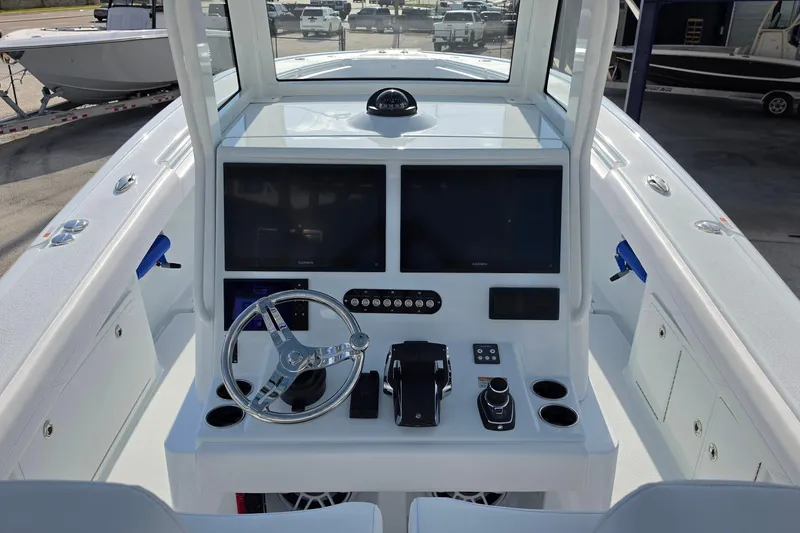 Slide: The Image of 2026 Yellowfin 36 Offshore boat cockpit with dual screens and steering wheel. - 16
