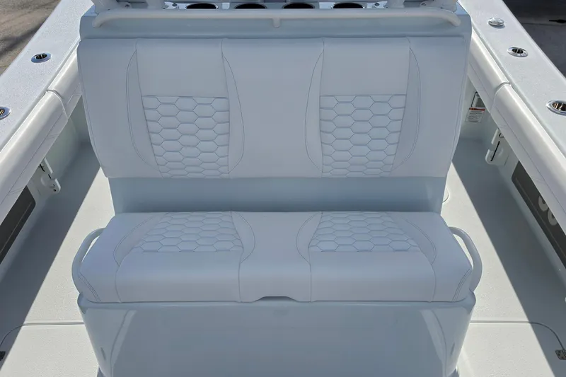 Slide: The Image of 2026 Yellowfin 36 Offshore boat with white cushioned seating and hexagonal stitching design. - 17