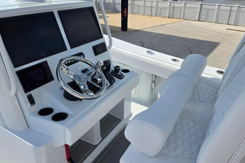 Slide: The Image of 2026 Yellowfin 36 Offshore boat cockpit with dual screens and white seating. - 20