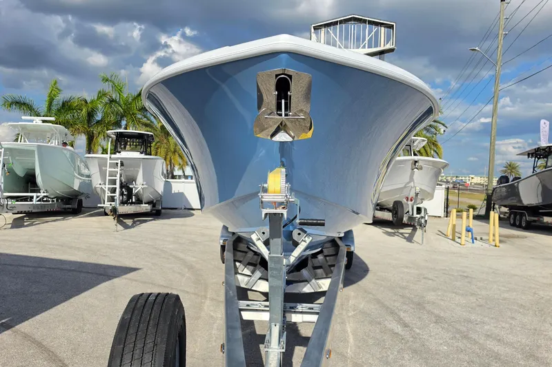 Slide: The Image of 2026 Yellowfin 36 Offshore boat on trailer, surrounded by palm trees and other boats. - 7