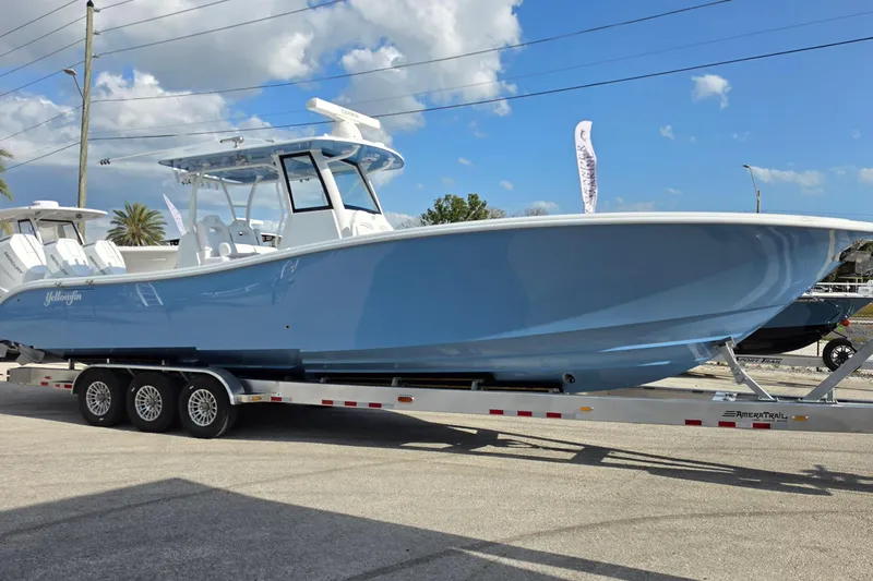 Slide: The Image of 2026 Yellowfin 36 Offshore boat on trailer under blue sky. - 9