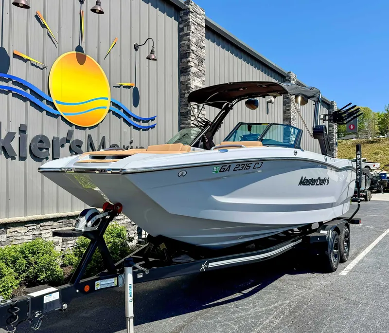 Slide: The Image of 2024 MasterCraft X24 boat on trailer at Skier's Marine. - 3