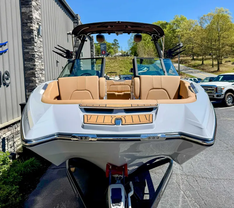Slide: The Image of 2024 MasterCraft X24 boat with luxurious interior, parked outdoors. - 4