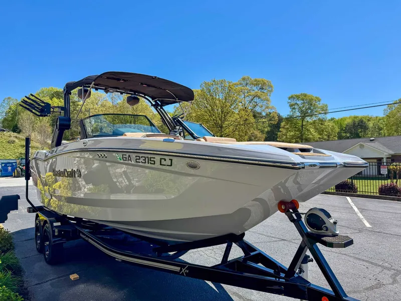 Slide: The Image of 2024 MasterCraft X24 boat on trailer in sunny weather. - 5