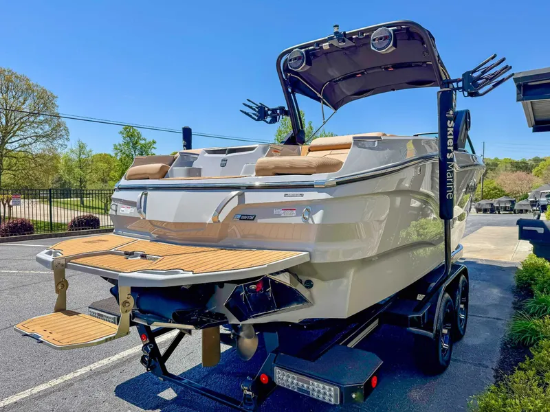 Slide: The Image of 2024 MasterCraft X24 boat on trailer, sunny day. - 6