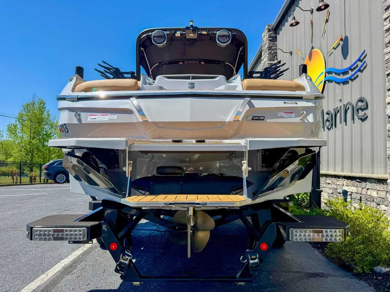 Slide: The Image of Rear view of a 2024 MasterCraft X24 boat in a parking lot. - 9