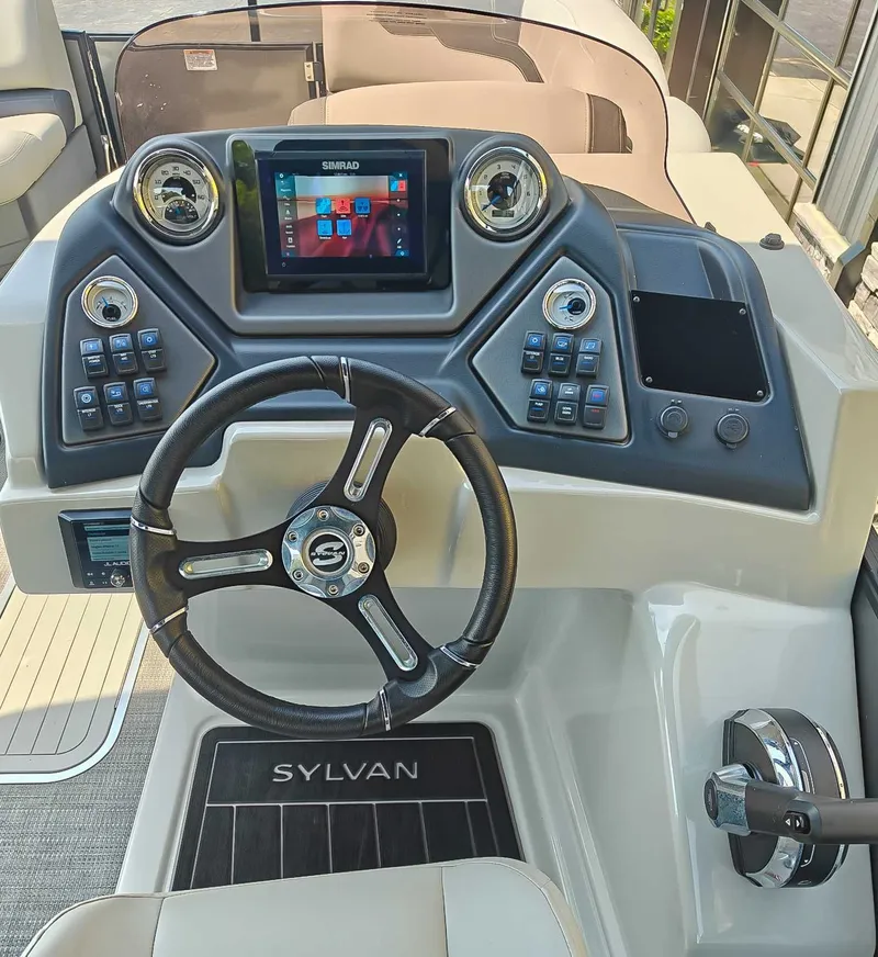 Slide: The Image of 2023 Sylvan L-3 CLZ DH boat dashboard with steering wheel and controls. - 12