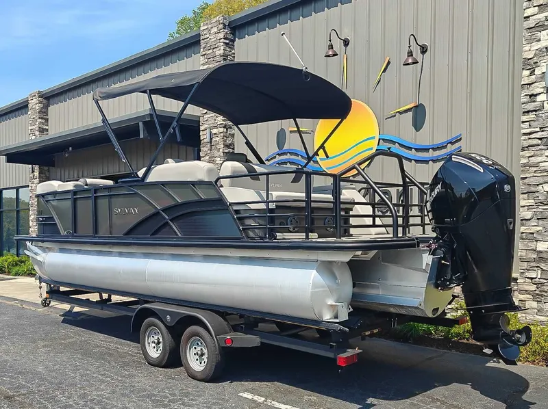 Slide: The Image of 2023 Sylvan L-3 CLZ DH pontoon boat parked outside a building. - 6