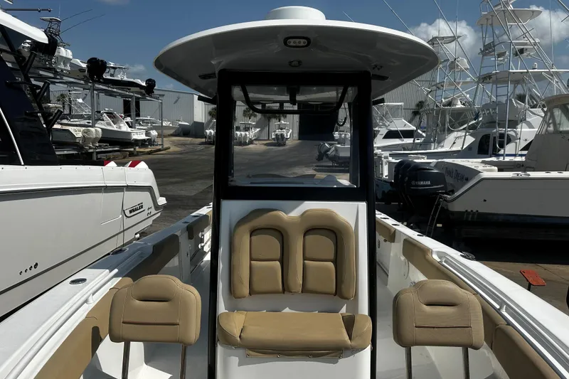 Slide: The Image of 2018 Sea Hunt Gamefish 27 boat with forward seating, docked among other vessels. - 3