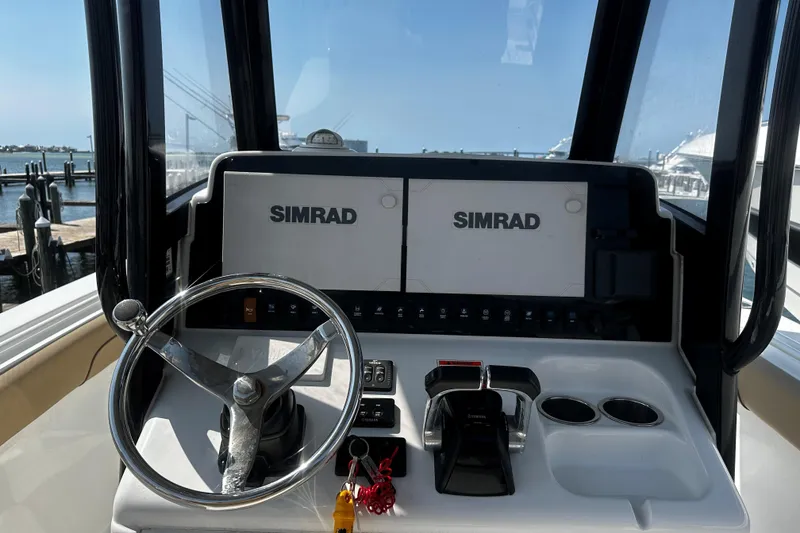 Slide: The Image of 2018 Sea Hunt Gamefish 27 helm with dual Simrad displays and steering wheel. - 4