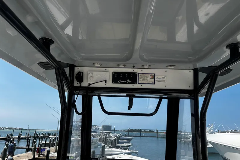 Slide: The Image of 2018 Sea Hunt Gamefish 27 boat interior with marina view in the background. - 5