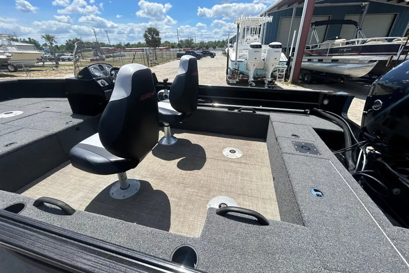 Slide: The Image of 2023 Competitor 165 SC boat interior with two seats and control panel. - 11