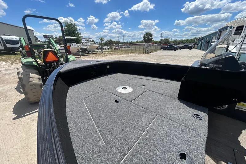 Slide: The Image of 2023 Competitor 165 SC boat on trailer, sunny day, tractor nearby. - 15