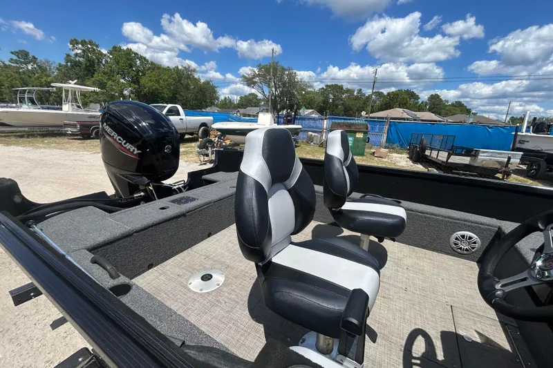 Slide: The Image of 2023 Competitor 165 SC boat interior with Mercury engine, featuring two seats and steering wheel. - 4