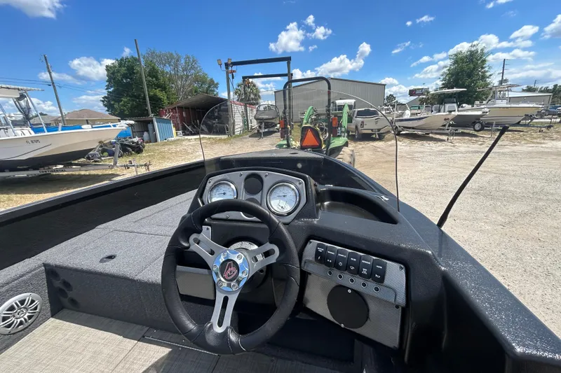 Slide: The Image of Interior view of 2023 Competitor 165 SC boat dashboard with steering wheel and gauges. - 5