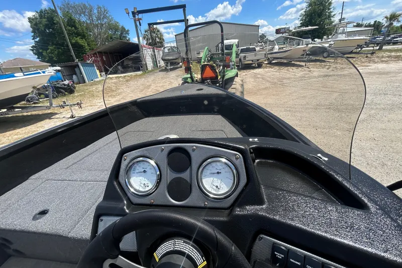 Slide: The Image of Interior view of 2023 Competitor 165 SC boat dashboard with gauges and steering wheel. - 6