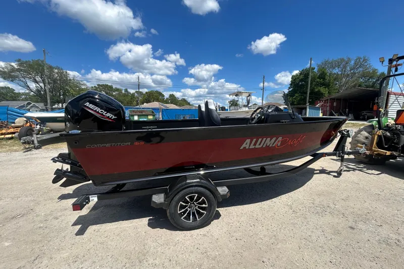 Slide: The Image of 2023 Alumacraft Competitor 165 SC boat on trailer, featuring Mercury outboard motor. - 8