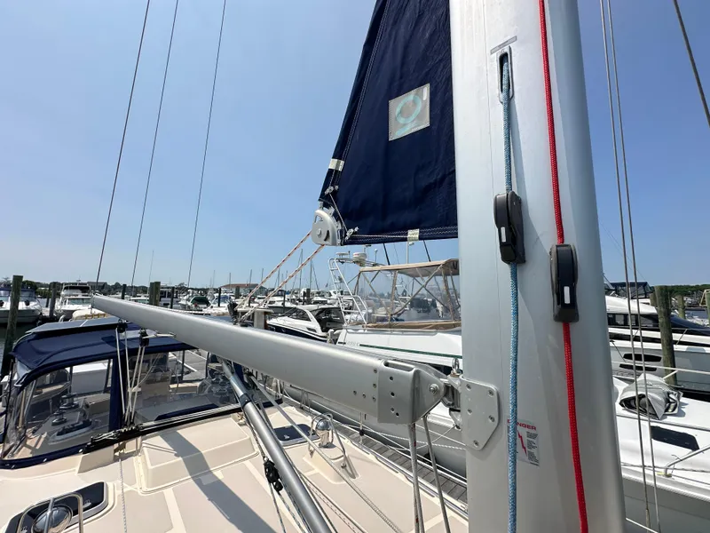 Slide: The Image of Sailboat Island Packet 439, 2021 model, docked at marina with visible mast and rigging. - 12