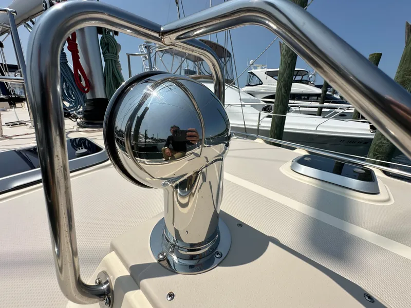 Slide: The Image of Chrome detail on 2021 Island Packet 439 yacht deck, reflecting marina scene. - 13
