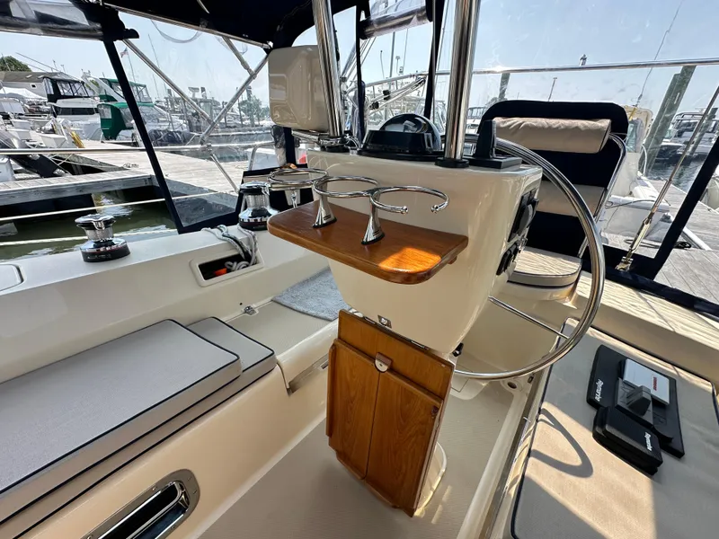 Slide: The Image of Island Packet 439 yacht cockpit with steering wheel and seating, 2021 model. - 23