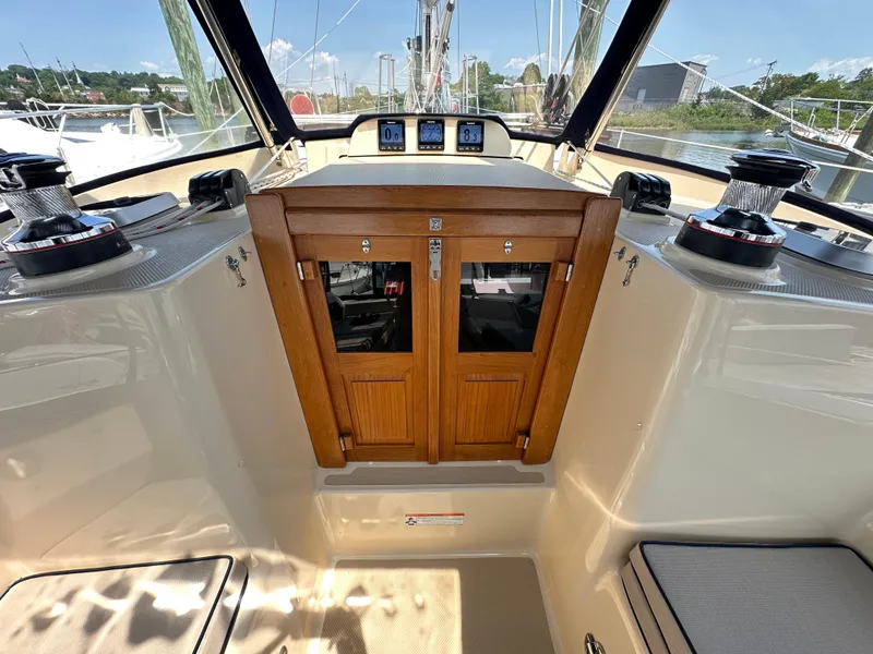 Slide: The Image of Cockpit of 2021 Island Packet 439 sailboat with wooden doors and navigation instruments. - 25