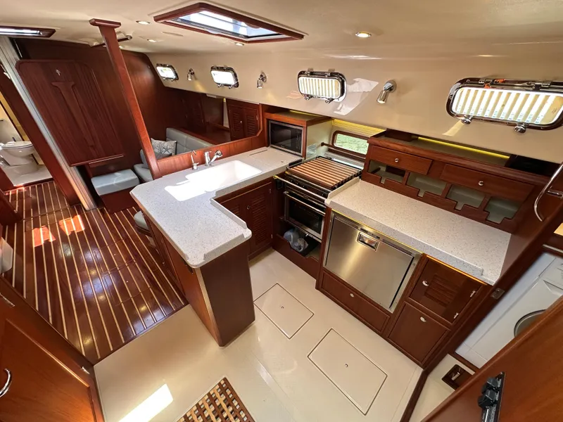 Slide: The Image of Luxurious interior of 2021 Island Packet 439 yacht with modern kitchen and elegant wood finishes. - 29