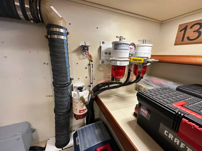 Slide: The Image of Engine room of 2021 Island Packet 439 with fuel filters and toolboxes. - 36
