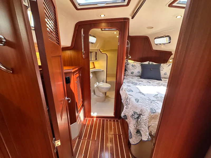 Slide: The Image of Luxurious cabin interior of 2021 Island Packet 439 yacht with wood finish and cozy bedding. - 40