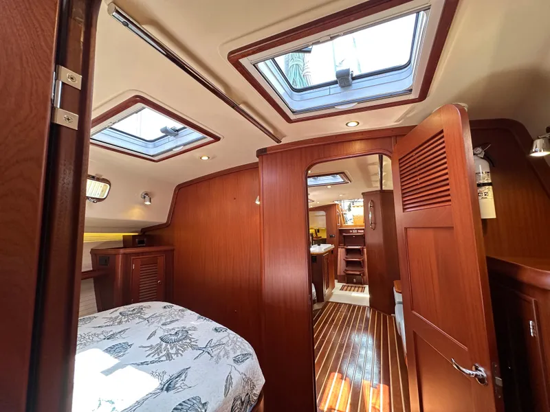 Slide: The Image of Interior of 2021 Island Packet 439 yacht with wood finish and skylights. - 45