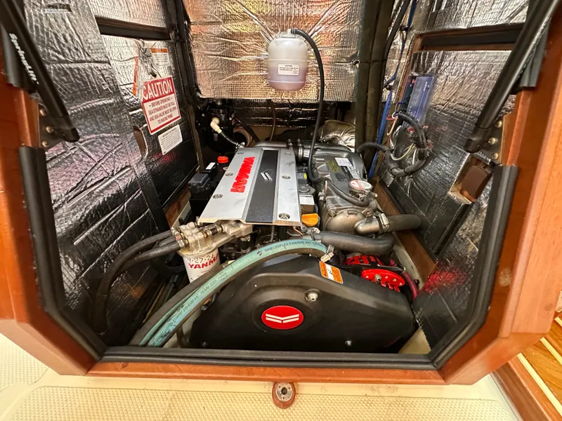 Slide: The Image of Engine compartment of a 2021 Island Packet 439 sailboat, featuring a Yanmar engine. - 49