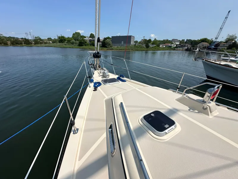 Slide: The Image of Sailing yacht Island Packet 439, 2021 model, docked on calm waters under clear skies. - 7